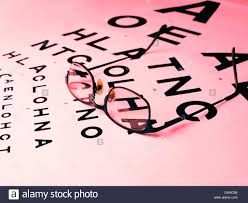 Pair Of Glasses Laying On An Opticians Eye Chart Stock Photo