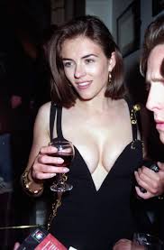 Hurley's black versace dress, riven with deep slits and seemingly held together by a string. The Story Behind Liz Hurley S Black Versace Safety Pin Dress Popsugar Fashion
