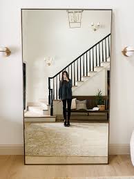 You can lean an oversized floor mirror in a corner in the bedroom for an instant dressing area or you can hang one in the hallway to make it look longer and more spacious. A Game Of Musical Furniture And A New Grand Mirror In The Entry Chris Loves Julia