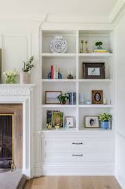 Flanking The Fireplace The Built In Bookcases Feature Beautiful Decor See Source Bookshelves In Living Room Built In Shelves Living Room Living Room Built Ins
