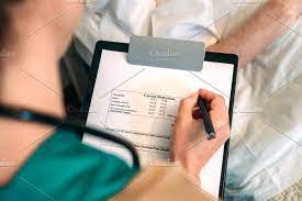 Female Doctor Filling Out A Questionnaire Female Doctor Doctor Female