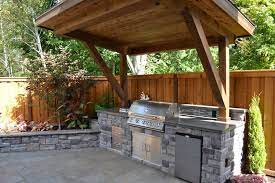 Paired with reclaimed wood or stone, these sorts of finishes will give your rustic kitchen a modern sensibility. Rustic Patio With Polished Concrete Outdoor Kitchen Raised Beds Stacked Stone Fence Exterior Stone F Rustic Outdoor Kitchens Rustic Patio Backyard Kitchen