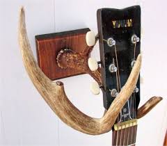 Our guitar wall mount turns your guitar into super cool wall decor and safely stores it when you're not showing off your skills. Diy Guitar Wall Mount Made From Deer Antler Way Neat Guitar Wall Guitar Display Wall Wood Guitar Stand