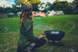 Barrow also doubles as, barbecue and barrow can be your fire pit, barbecue and a grill for some amazing summer parties. A Young Woman Is Enjoying A Glass Of Wine By A Fire Pit On A Camp Site On A Summer Evening Stock Photo Picture And Royalty Free Image Image 135185046