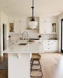 As the picture shows, the white marble backsplash and countertop catch the eye. 20 Kitchen Backsplash Ideas For White Cabinets