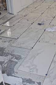 Measure the entire room and determine how many tiles you'll need for the job. Beginner S Guide To Laying Tile A Beautiful Mess How To Lay Tile Tile Floor Diy Diy Flooring