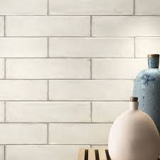 White beveled brick tiles create a lustrous backsplash display paired with white quartz countertops, white raised panel cabinets accented with bronze add a stylish look to interior bathroom and kitchen walls by choosing these white metro brick ceramic tiles. Gorgeous White Brick Wall Tiles Free Samples And Low Prices