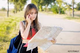Tourist girl looking for direction on the map and asking for help ...