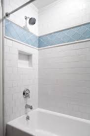 Placing a border of accent tiles at the very bottom of your shower stall will give it an anchored look, similar to the way trim is placed in various rooms of your home. White Traditional Shower With Blue Tile Accent Hgtv