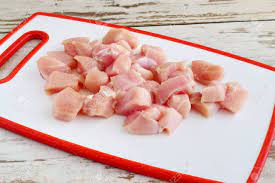 Cut the chicken thighs into 1 in × 1 in (2.5 cm × 2.5 cm) pieces so they fit well on the kebabs. Chicken Fillet Cut In Cubes On A White Cutting Board Step By Stock Photo Picture And Royalty Free Image Image 80193486