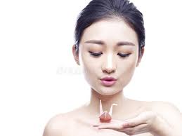 Paper Crane Inside a Crystal Glass and a Paper Parrot Drinking O Stock  Photo