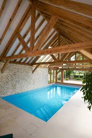 Farmhouse Styled Pool Enclosure With Beams And Mosaic Tiles Walls Pale Beige Tiles Flooring Simple R Indoor Swimming Pool Design Swimming Pools Building A Pool