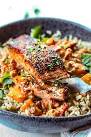 Far Away Iew Of Pan Seared Blackned Salmon On Rice In Black Bowl With Sauce Seared Salmon Recipes Salmon Recipe Pan Salmon Dishes
