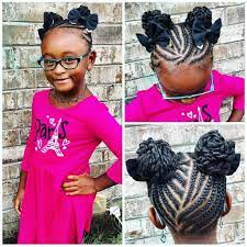 Little Black Girl With Cornrows Leading To Two Braided Buns Adorned With Hair Bows Kids Braided Hairstyles Kids Hairstyles Braided Bun Hairstyles