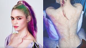 I think the new grimes tattoo is absolutely amazing and beautiful idk what y'all are on abt pic.twitter.com/qpkel9bcfu. Grimes Shows Off New Tattoo Of Beautiful Alien Scars