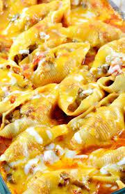 Mexican Stuffed Shells Recipe Filled With A Ground Beef And Cream Cheese Mixture Cooked In A Bath Of Enchilada Sauce And S Recipes Mexican Food Recipes Food