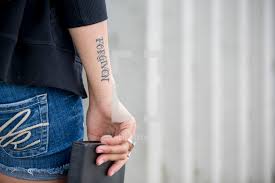 For a two inch forgiven tattoo. Woman With A Forgiven Tattoo Holding A Bible Photo Lightstock