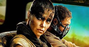 Charlize theron's stunt double reveals mad max cast stayed in character 24/7 and sheds light on feud with tom hardy. 