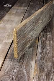 Reclaimed rough cut lumber barnwood 1x's with worn red paint. Reclaimed Lime Washed Barn Wood Cladding