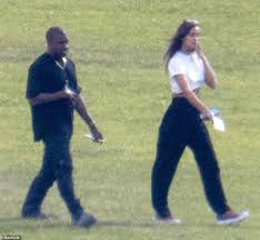 Dressed in casual clothing in the pics, the duo walked around a grassy area as west smiled wide. Axmihqiezsqpym