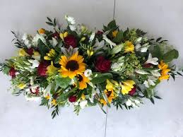 Available in a variety of colors and styles, casket sprays become an expression of a unique life that was well lived. Casket Spray Sunflower Mix Buy Online Or Call 01525 221920