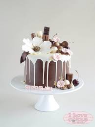Drippy Chocolate Cake With Beautiful Flowers Decorating The Top Drippy Cakes Drip Cakes Cake