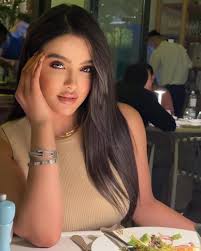 Which pillow is an accurate reflection of the window?