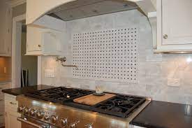 Tiling a backsplash includes planning how to install the tile around various outlets that can be used for electric or for video. Carrera Marble Basket Weave Backsplash Kitchen Design Kitchen Kitchen Stove