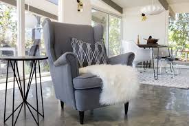 We Love How Ikea S Strandmon Chair Looks Right At Home Here The Pillow S Geo Pattern Echoes The Side Table Legs Madis Green Dining Room Ikea Strandmon Home