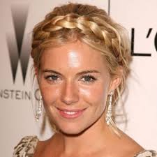 Parted Down The Middle She Braided The Two Sides Separately And Is Looking A Little Bohemian In This Simple Style Milkmaid Braid Hair Styles Goddess Hairstyles