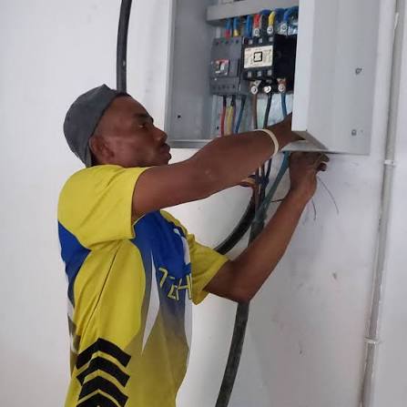 Fitter checking a switchboard after socket fitting work in Greenwich SE10