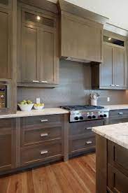 The color of these kitchen cabinets is lunar grey and it works so well with brass hardware. Interesting Cabinet Color Shaker Style Kitchen Cabinets Contemporary Kitchen Cabinets Taupe Kitchen
