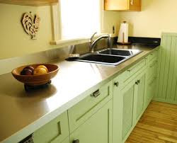 Stainless steel countertops in a white kitchen with warm details. Stainless Steel Countertop By Ridalco Klassisch Kuche Ottawa Von Ridalco Stainless Steel Houzz