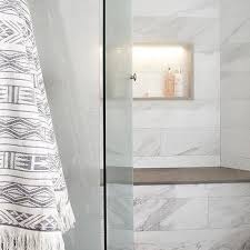 This bathroom with two sinks and a makeup counter in the middle makes great use of the quartz by having the crisp, clean lines mimic the lines on the cabinetry. Gray Quartz Shower Bench Top Design Ideas