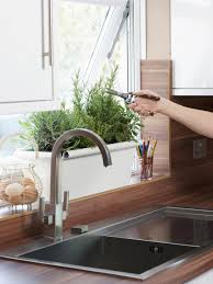 If you have space in front of a kitchen window, plant the herbs in small containers for an indoor garden. How To Plant And Grow Herbs Indoors Kitchen Herb Garden Tips Hgtv
