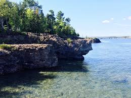 Aside from the height, the dark color of the cliffs adds a dramatic landscape to the shoreline along the tip of presque isle park. Black Rocks In Marquette Michigan