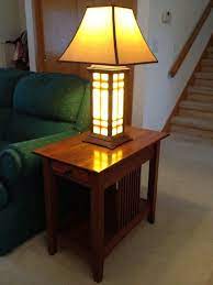 The room's two ottomans and one chair serve as additional seating for company. End Table Lamps Online