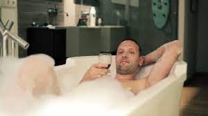 Romantic date in cozy hotel or cabin lodge next to scented candles. Man Relaxing In Bathtub With Wine Video By C Motion Pl Stock Footage 43712947