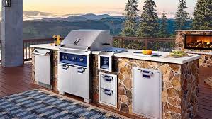 We're loving this entertaining spot for its sleek stone fireplace and grill station. Outdoor Kitchen Ideas Inspiration Bbqguys