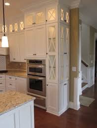 Sometimes glass front cabinets are used on base cabinets for display cabinets. Tall White Narrow Cabinets Top Lit Glass Doors Light Counters Hardwood Flooring Tall Kitchen Cabinets Traditional Kitchen Cabinets Kitchen Wall Cabinets