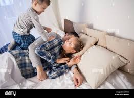 mom dad and young son in the bedroom after sleeping House Stock Photo -  Alamy