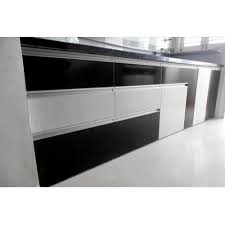 Contemporary arrangement for a black and white kitchen, furnished with a set of cabinets and counters made out of solid wood with a white coat of paint, contrasted by the kitchen appliances. Black And White Rectangular Pvc Modular Kitchen Cabinet Rs 350 Square Feet Id 21495358612