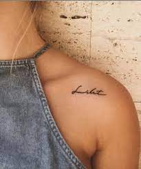 30 Best Tiny Words Tattoo Ideas To Ink On Your Body Shoulder Tattoos For Women Tattoos For Women Shoulder Tattoo