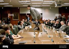 FILE— Michigan State student Connor Berry, 22, climbs atop the table to  make a statement in protest as the MSU board of trustees meets and votes to  name former Gov. John Engler