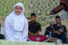 Woman collapses in pain as she's caned for 'obscenity on social media' under Sharia law
