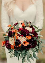 Burgundy is a very popular color for wedding, add it to your color palette for a stunning display of deep, moody flowers. Autumn Wedding Bouquet Comprised Of Burgundy Dahlias Flame Calla Lilies Sahara Roses Orange Fall Wedding Bouquets Bridal Bouquet Fall Flower Bouquet Wedding