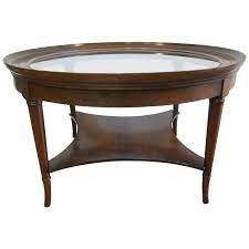 Mahogany coffee table has beveled glass top, gadroon molding on top edge, herringbone walnut inlay and tapered fluted legs with marlborough feet. Kittinger Saber Leg Cocktail Table At 1stdibs