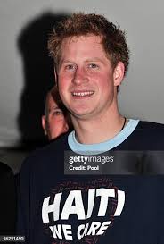 Prince Harry holds young patient Tyrell Richards when he visits the... News  Photo