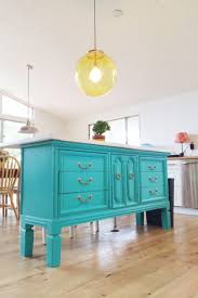 An antique bakery table, equipped with pottery barn baskets, functions as the kitchen island. Diy Kitchen Island Ideas Makes And Munchies