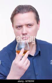 Man smelling glass of brandy Stock Photo